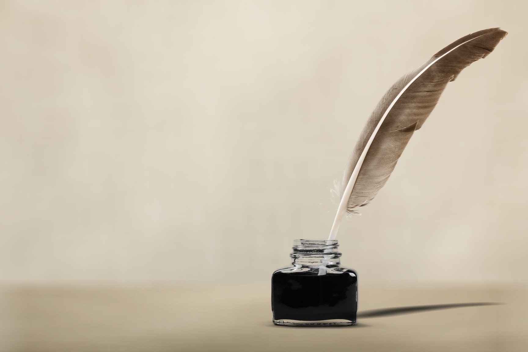 Quill Pen with Inkwell  on Wooden Desk. Vintage Old Style Sepia Photography